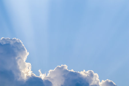 Background from blue sky with sun rays across clouds. High quality photoの写真素材