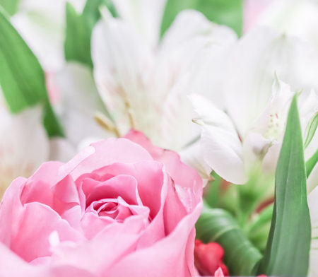Beautiful pink rose in flower arrangement. Decoration of roses and ornamental plants, selective focusの写真素材
