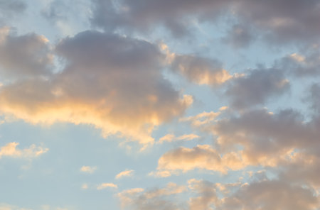 Background of blue sky with golden clouds at sunsetの写真素材
