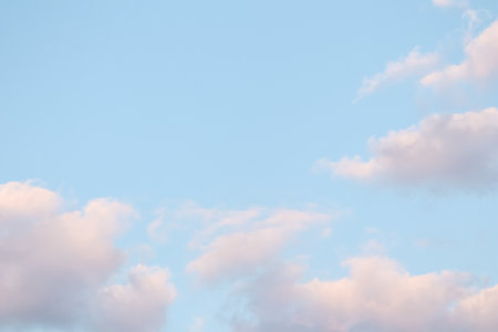 Background of blue sky with pale pink clouds at sunsetの写真素材