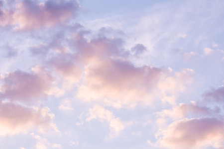 Background of blue sky with pale pink clouds at sunsetの写真素材