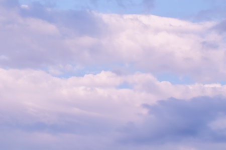 Blue sky background with white and pink clouds at sunset. high quality photoの写真素材