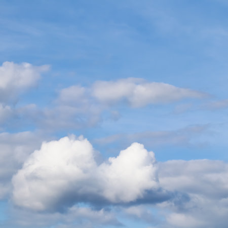 Background of blue sky with white clouds. Natural backdropの写真素材