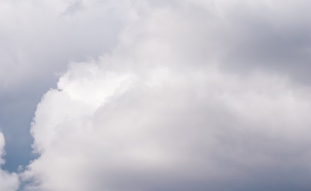 Cloudy sky background with white and gray clouds. Natural background