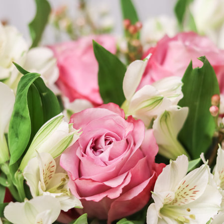 Beautiful pink rose in flower arrangement. Decoration of roses and ornamental plants, selective focusの写真素材