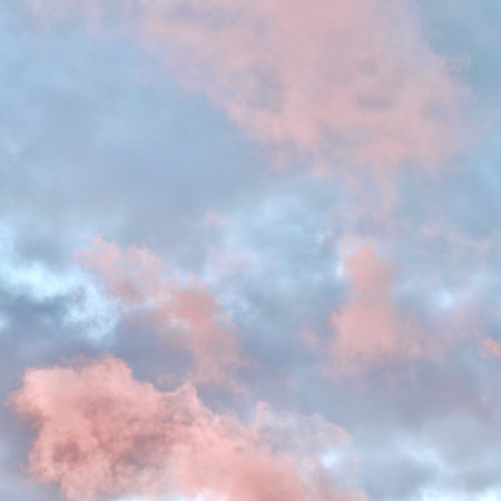 A dreamlike atmospheric scene where a dramatic mass of pink and peach clouds glows against a pale...