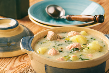 Potato soup with salmon, leek, sour cream and parsley.の写真素材
