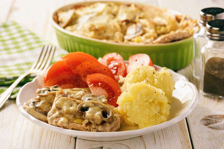 Grilled pork tenderloin with bechamel sauce, mushrooms and mashed potatoes.の写真素材