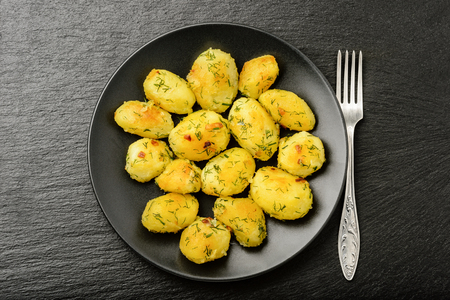 Roasted young potatoes with garlic and dillの写真素材