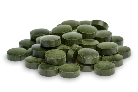 Spirulina pills (superfood) isolated on white background.の写真素材