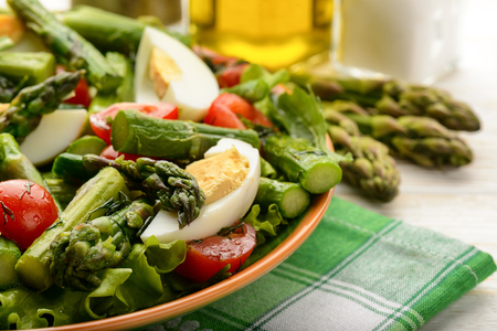 Delicius salad with green asparagus, tomatoes and eggs.の写真素材