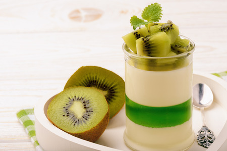 Panna cotta with kiwi jelly and kiwi fruits.の写真素材