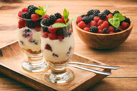 Healthy yogurt dessert with muesli, raspberries and blackberries.の写真素材