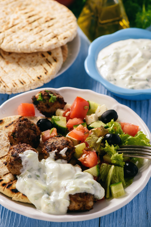 Greek meatballs (keftedes) with pita bread and tzatziki dip.の写真素材
