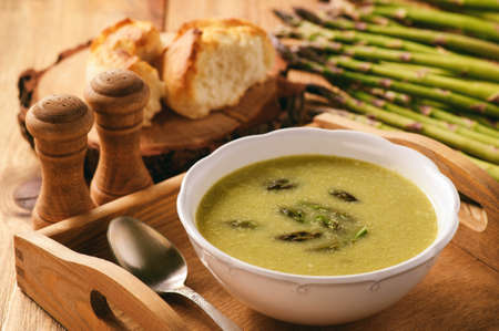 Asparagus cream soup on wooden tray.の写真素材