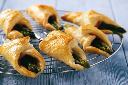 Asparagus baked in puff pastry with ham and cheese.の写真素材