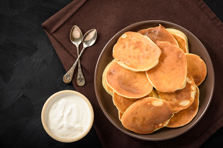 Homemade pancakes on black background.