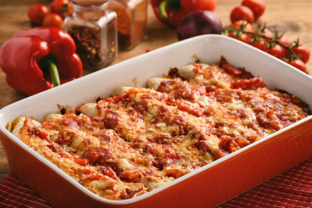 Enchiladas - mexican food, tortilla with chicken, cheese and tomatoes.