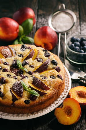 Homemade cake with nectarines and blueberries.の写真素材