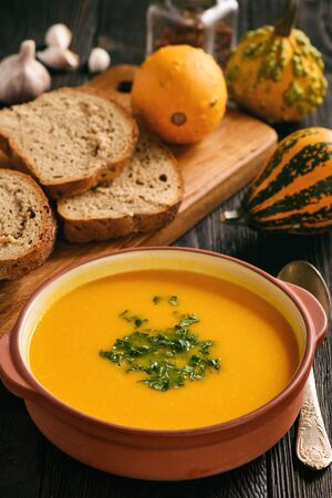 Homemade pumpkin cream soup on black background.の写真素材