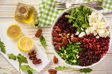 Salad with wild rice, arugula, pomegranate, pecan nuts, cranberries and feta cheese.の写真素材