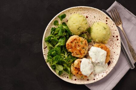 Chicken cutlets served with mashed potatoes, salad and garlic dip.の写真素材