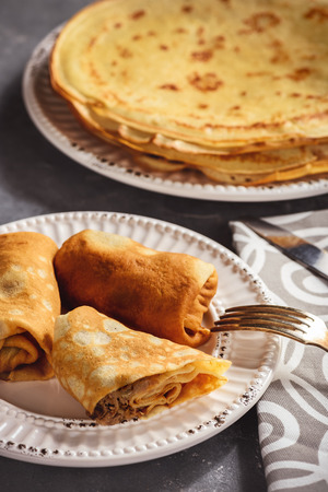 Pancakes stuffed with meat, on dark background.の写真素材