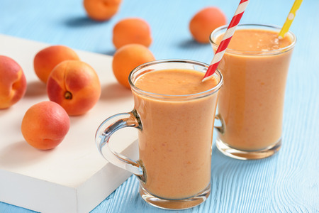 Apricot smoothie, healthy beverage, on wooden background.の写真素材
