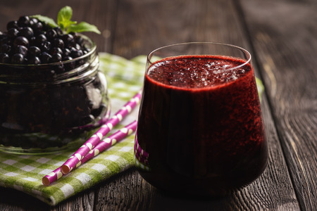Blueberry smoothie in glass, on dark background.の写真素材