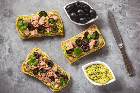 Bruschetta with tuna, olives and avocade spread.の写真素材