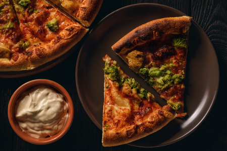 Homemade pizza with chicken and broccoli.の写真素材