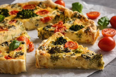 Homemade tart with broccoli, tomatoes and blue cheese.の写真素材