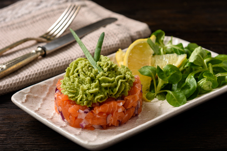 Salmon tartare with guacamole, on darkの写真素材
