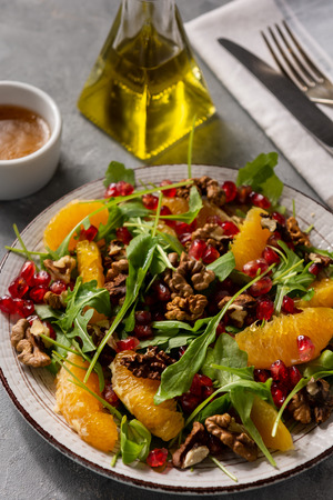 Arugula salad with oranges, walnuts and pomegranate.の写真素材
