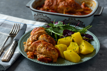 Oven-baked chicken breast served with mozzarella and tomatoes, served with potatoes.の写真素材