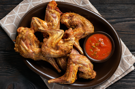 Grilled rabbit legs with spicy tomato dip.の写真素材