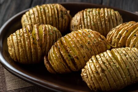 Hasselback potatoes baked with garlic and herbs in oven.の写真素材