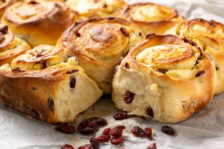 Homemade sweet bread buns with cottage cheese and cranberries filling.