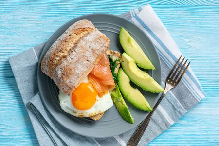 Spinach, smoked salmon and runny egg sandwiches.の写真素材