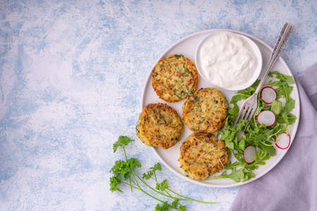 Zucchini fritters served with yogurt dip.の写真素材