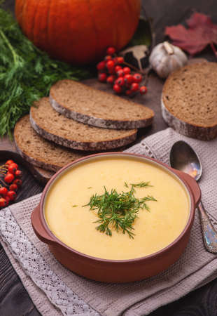 Pumpkin soup with cream and dill in a bowl.の写真素材