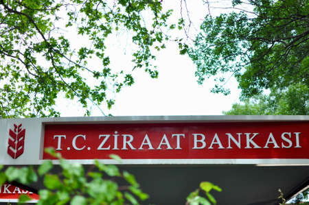 Ankara Turkey. June 2021. Signboard of Ziraat Banksi., Agriculture Bank among trees. A TC bank founded in 1863 with mission to help farmers and agricultural development in Turkey. Wheat harvest logo.のeditorial素材