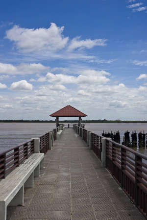 walk way to riverside at thai gulf under blue skyの写真素材
