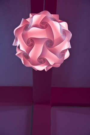 pink lighting hanging on ceiling の写真素材