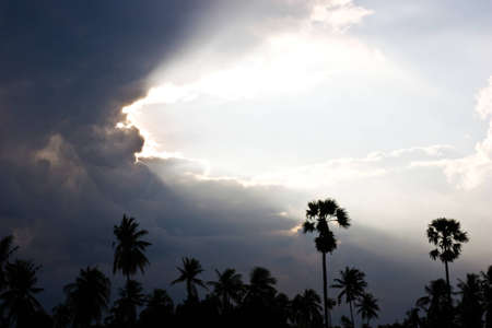 sun light hiding at back of cloudyの写真素材