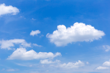 Blue sky background with white clouds, rain clouds on sunny summer or spring day.の写真素材