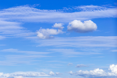 Blue sky background with white clouds, rain clouds on sunny summer or spring day.の写真素材