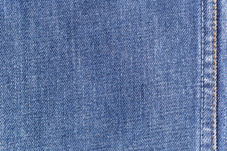 Denim jeans fabric texture background with seam for clothing, fashion design and industrial construction concept.の写真素材