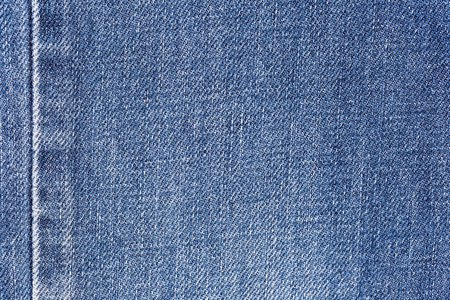 Denim jeans fabric texture background with seam for clothing, fashion design and industrial construction concept.の写真素材