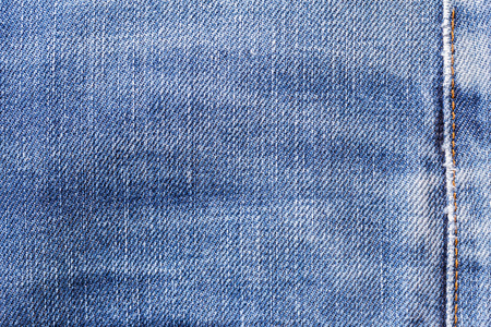 Denim jeans fabric texture background with seam for clothing, fashion design and industrial construction concept.の写真素材